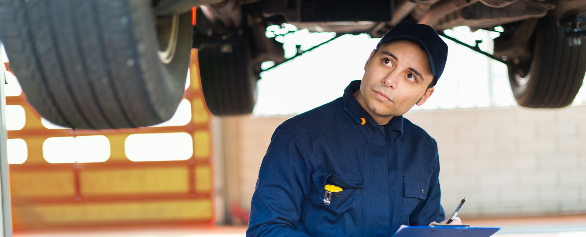 technican checking over a vehicle for its MOT - MOT Testing Wrexham